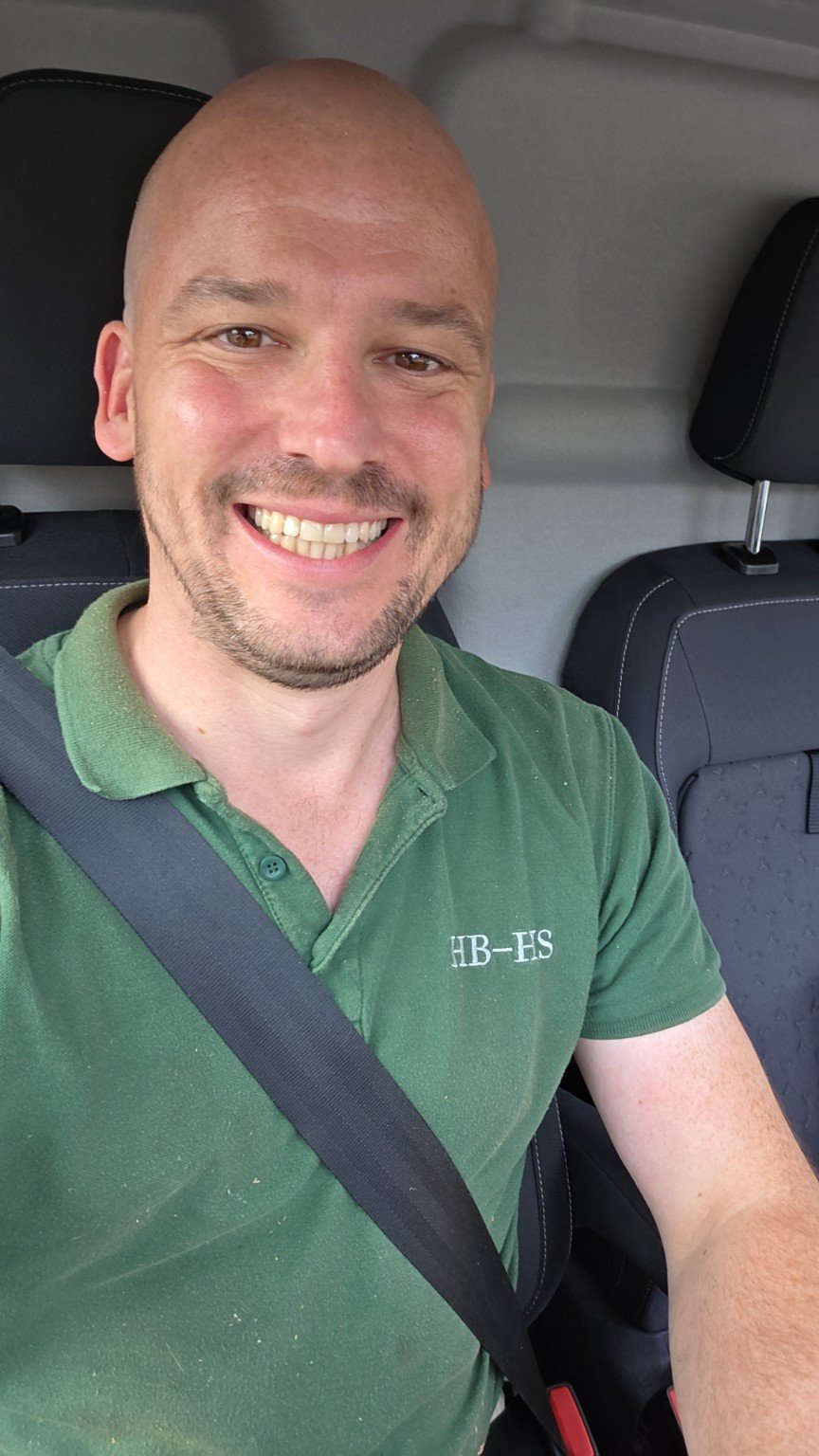 Luke smiling in his green HB-HS branded polo